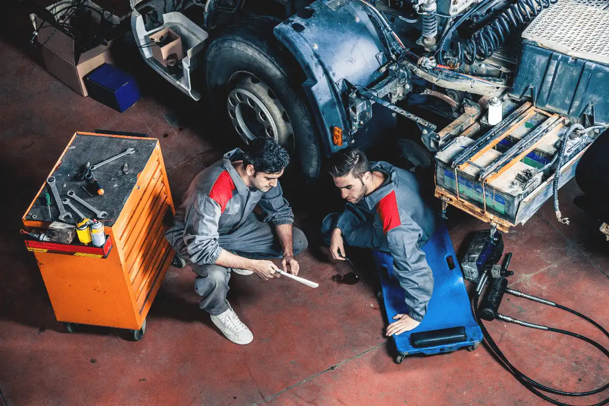 Professional mechanics inspecting a truck engine, representing Applifast’s commitment to heavy-duty tooling solutions.